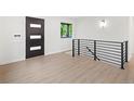 Bright entryway with sleek black accents, modern black door and stairway, and durable floors at 1238 Rosemary St, Denver, CO 80220