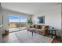 Living room showcasing a sliding glass door to the balcony and a comfortable seating area at 700 N Washington St # 1104, Denver, CO 80203