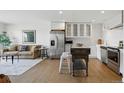 Open living space featuring hardwood floors, stainless steel appliances, and combined living and kitchen at 700 N Washington St # 1104, Denver, CO 80203