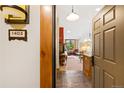 Inviting entryway featuring tile flooring, wood trim, and a view into the living room with warm lighting and decor at 50 Mountain Thunder Dr # 1402, Breckenridge, CO 80424