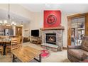 Inviting living room featuring a stone fireplace, open layout, and rustic wood accents throughout the room at 50 Mountain Thunder Dr # 1402, Breckenridge, CO 80424