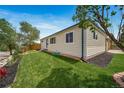 Charming single-Gathering home featuring a well-kept lawn, and manicured garden beds at 4640 W Ellsworth Ave, Denver, CO 80219