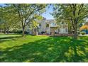 Expansive backyard with lush lawn and a brick patio, perfect for outdoor entertaining at 7 Mockingbird Ln, Cherry Hills Village, CO 80113