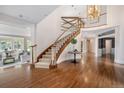 Grand foyer with a striking staircase, hardwood floors, and elegant lighting fixtures, offering a luxurious entrance at 7 Mockingbird Ln, Cherry Hills Village, CO 80113