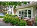 Charming patio area with brick accents and lush greenery, perfect for outdoor seating and relaxation at 7 Mockingbird Ln, Cherry Hills Village, CO 80113