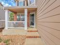 Charming front porch with seating area, brick accents, and a welcoming entrance, creating a cozy curb appeal at 10062 Eagle Valley Way, Highlands Ranch, CO 80129
