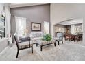 Bright living room featuring vaulted ceiling, neutral decor, and dining area, creating a welcoming atmosphere at 10062 Eagle Valley Way, Highlands Ranch, CO 80129