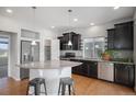 Modern kitchen featuring stainless steel appliances, dark cabinets, granite counters and eat-in island at 3116 Jonquil St, Castle Rock, CO 80109