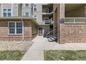 Apartment building entryway features brick accents, stair access, and clearly marked unit numbers at 12818 Ironstone Way # 101, Parker, CO 80134