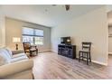 Living room with hardwood floors, modern furniture, large windows, and lots of light at 12818 Ironstone Way # 101, Parker, CO 80134
