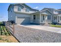 Charming two-story home featuring an attached garage and a welcoming covered front porch at 5805 Red Barn Ave, Mead, CO 80504