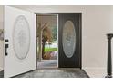 Inviting entryway with decorative glass doors, creating a warm welcome into the home at 6602 S Vance St, Littleton, CO 80123