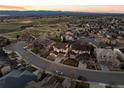 Neighborhood aerial shot showcasing well-maintained homes, green spaces, and a scenic view of the mountains at 2577 Shadecrest Pl, Highlands Ranch, CO 80126