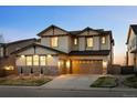 A two-story home with stone accents, well-manicured lawn, and a welcoming entrance at 2577 Shadecrest Pl, Highlands Ranch, CO 80126
