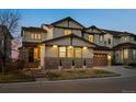 Charming two-story home with stone accents, a well-manicured lawn, and a welcoming entrance at 2577 Shadecrest Pl, Highlands Ranch, CO 80126