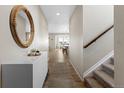Inviting entryway with modern decor, hardwood floors, and stairs leading to the upper level at 21650 E Tufts Cir, Aurora, CO 80015