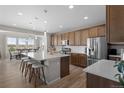Spacious kitchen boasts a large center island, stainless steel appliances, and ample cabinet space at 21650 E Tufts Cir, Aurora, CO 80015