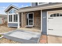 Inviting covered front porch with brick accents and a well-maintained entrance, showcasing the home's curb appeal at 9392 Crestmore Way, Highlands Ranch, CO 80126