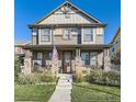 Charming two-story home featuring a welcoming front porch and well-maintained landscaping at 21851 E Tallkid Ave, Parker, CO 80138