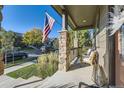 Inviting porch with stone columns and ample seating to enjoy the neighborhood at 21851 E Tallkid Ave, Parker, CO 80138