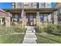 Inviting porch with stone columns and ample seating to enjoy the neighborhood at 21851 E Tallkid Ave, Parker, CO 80138