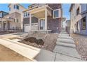 Landscaped front yard featuring stone and wood chip accents and concrete walkways to the entrance at 11902 Octave Ave, Parker, CO 80134