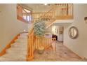 Spacious entryway featuring a staircase with wood railing and tile flooring at 8136 S Glencoe Ct, Centennial, CO 80122