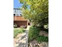 Charming townhome entrance with lush landscaping and a brick exterior facade at 1111 Maxwell Ave # 228, Boulder, CO 80304