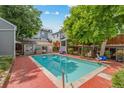 Community pool area with lush trees and plenty of lounge space for tenants to enjoy the summer heat at 1111 Maxwell Ave # 228, Boulder, CO 80304