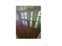 Sunlit living room showcasing hardwood floors and large windows at 11761 E Canal Dr, Aurora, CO 80011