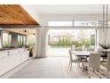 Bright dining room with outdoor views and access, alongside a modern living space at 140 S Glencoe St, Denver, CO 80246