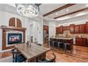 Open concept living space with a fireplace, modern kitchen, and hardwood floors at 7821 Inverness Blvd, Englewood, CO 80112