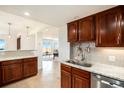 Cozy kitchen featuring granite countertops and wood cabinetry at 1029 E 8Th Ave # 1302, Denver, CO 80218