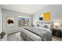 Calm bedroom with a large window, stylish headboard, soft gray tones, and minimalist decor at 8755 W Cornell Ave # 14-5, Lakewood, CO 80227