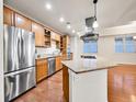 Bright kitchen featuring stainless steel appliances, custom cabinets, and a granite island at 2200 S University Blvd # 105, Denver, CO 80210