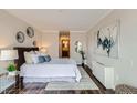 Cozy bedroom with decorative wall art and ensuite bathroom access at 1050 N Corona St # 304, Denver, CO 80218