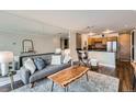 Open concept living room featuring a large mirror wall and modern decor at 1050 N Corona St # 304, Denver, CO 80218