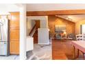 Bright living room with hardwood floors, wood paneled accent wall, and a fireplace at 9400 E Iliff Ave # 411, Denver, CO 80231
