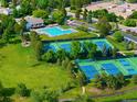 Aerial view of the community pool and tennis courts surrounded by lush greenery at 9502 W Hialeah Pl, Littleton, CO 80123