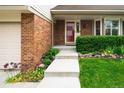 Inviting front entrance with a well-maintained lawn, garden bed, and a clear pathway to the front door at 9502 W Hialeah Pl, Littleton, CO 80123
