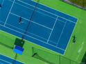 Aerial view of tennis court with players in action at 9502 W Hialeah Pl, Littleton, CO 80123