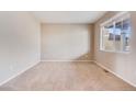 Bedroom features neutral walls, plush carpeting, and a large window at 10294 E Telluride Ct, Commerce City, CO 80022