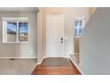 Inviting foyer with hardwood floors, neutral walls, and plenty of natural light at 10294 E Telluride Ct, Commerce City, CO 80022