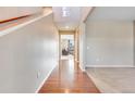Hallway with hardwood floors leading into the living room area at 10294 E Telluride Ct, Commerce City, CO 80022