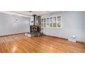 Living room with hardwood floors and a wood burning stove at 8550 E Davies Pl, Centennial, CO 80112