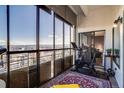Enclosed balcony with floor to ceiling windows offers stunning city views and exercise area at 800 N Pearl St # 1207, Denver, CO 80203