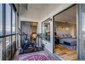 Balcony with a Peloton bike and a cozy seating area connecting to the bedroom and living room at 800 N Pearl St # 1207, Denver, CO 80203