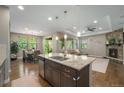 Open concept kitchen with granite island, stainless appliances, and an adjacent living and dining area at 24028 E Caleb Pl, Aurora, CO 80016
