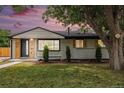 Charming, newly renovated single-story home with modern wood and painted brick exterior at 530 Everett St, Lakewood, CO 80226