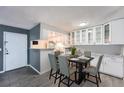 Charming dining area with sleek black table set for 6, opening to a modern kitchen at 3480 S Eagle St # 101, Aurora, CO 80014
